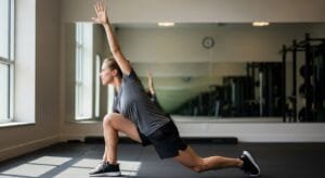 World's Greatest Stretch showing hip flexor stretch combined with thoracic spine rotation